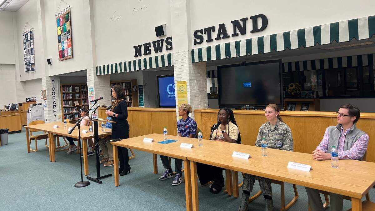Clover School District superintendent Sheila Quinn (middle) is standing in between Oakridge Middle School students (seated left) and Clover High School students (seated right) at a media event at Clover High School on Oct. 19.