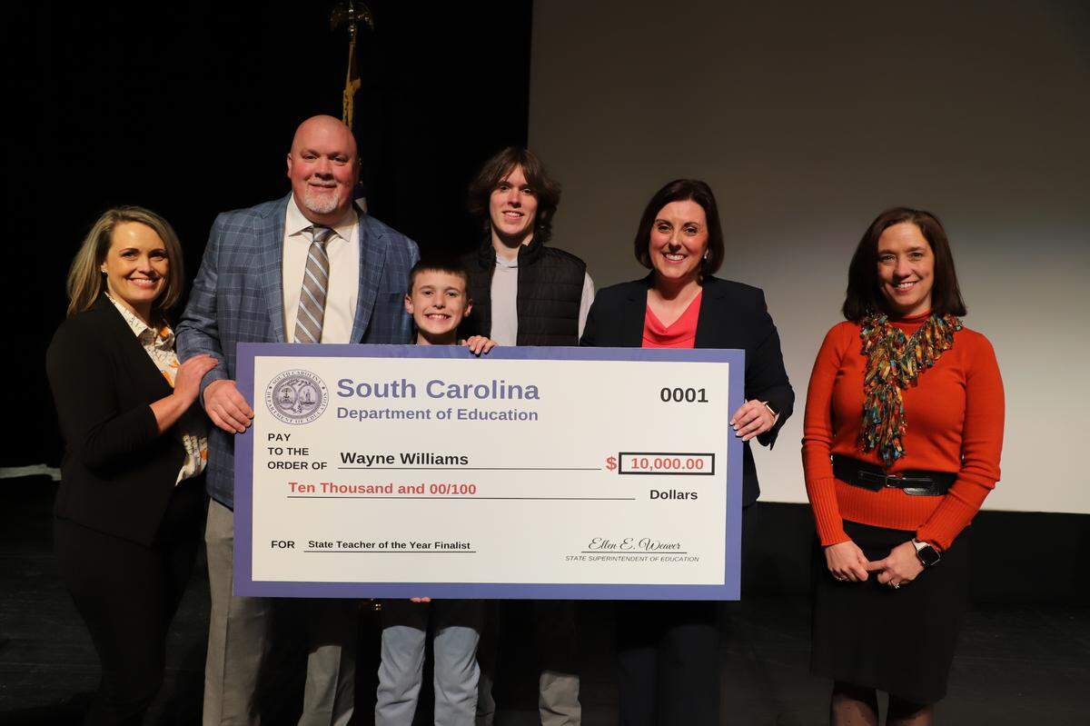 Holly Williams, Wayne Williams, Trent Williams (11), Braxton (18), state education superintendent Ellen Weaver and Clover School District superintendent Sheila Quinn at an event Wednesday recognizing Wayne Williams as a state Teacher of the Year finalist.