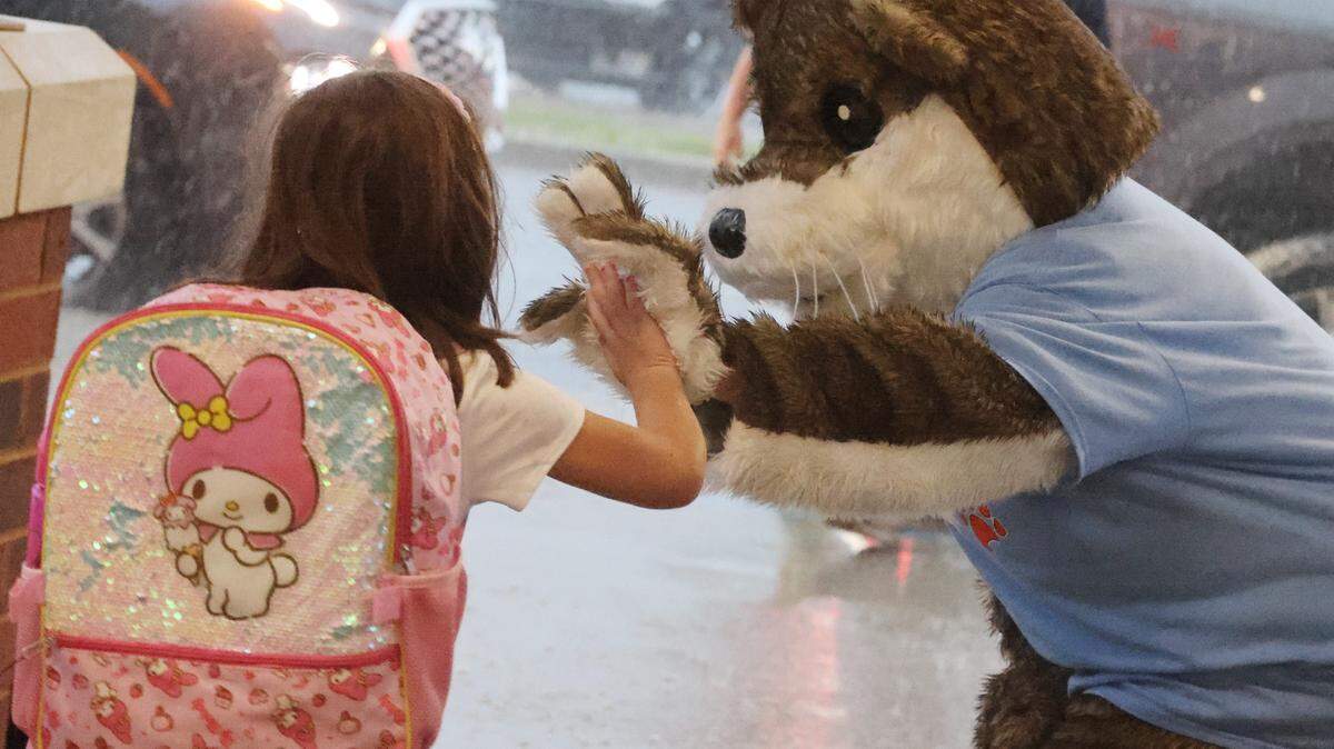 In this Herald file photo, a child gives Ollie the Otter a high-five at the drop-off line at River Trail Elementary School in Fort Mill on the first day of school. Fort Mill Town Council is speaking up against a state rule that could allow students from outside the Fort Mill district to attend its schools.