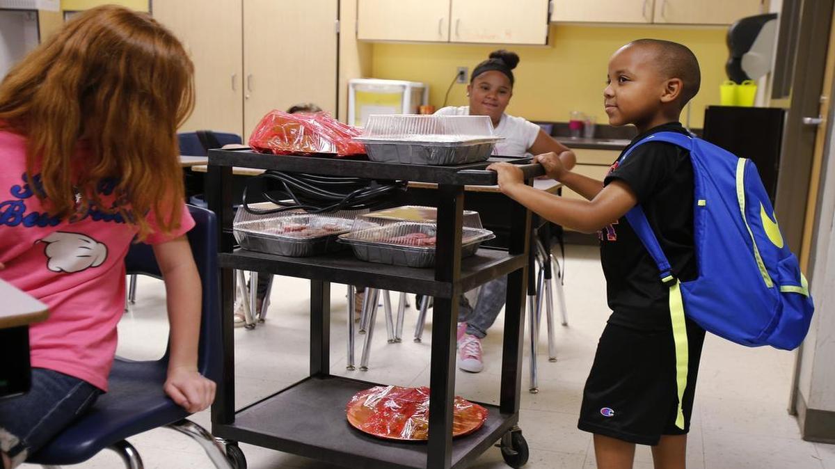 
Noble Williams pushes a cart with treats for his brother Norris' fifth-grade class. Noble, 5, has multiple food alergies to dairy, eggs, peanuts and treenuts. The treats were strawberry cupcakes made with out milk and eggs and strawberries and grapes.
