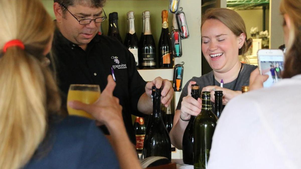 
Dave Sills, left, preps more bottles of prosecco to be consumed by the moms who have converged on his Grapevine Wine Bar to celebrate the first day of school in Fort Mill.
