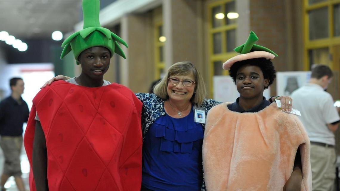 
Dr. Julie Marshall hugs students Devontae Murphy, left, and Devon Miles, right, during the health fair on Monday night at Saluda Middle School.
