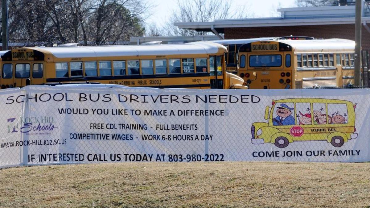 A sign advertises bus driver employment with the Rock Hill school district in front of Ebinport Elementary School.