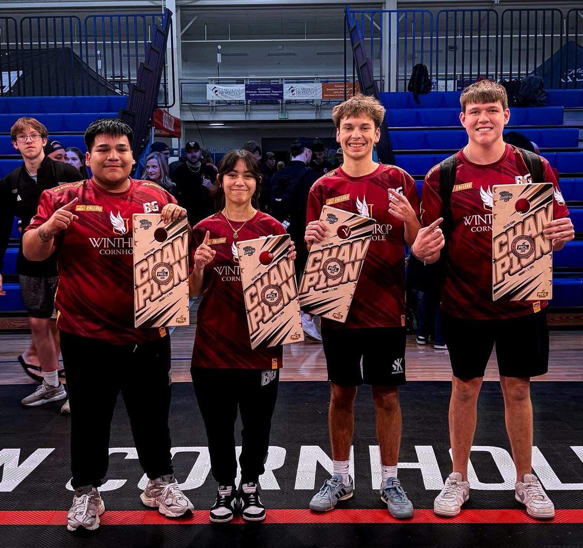 Winthrop Eagles Sal Sandoval, Mikayla Calvey, Hayden Gonzales and Dylan Graham celebrate after winning the team national championship for college cornhole.