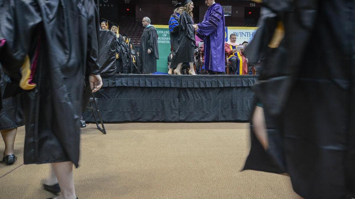 Graduates make their way to and from the stage during last year’s Winthrop University commencement ceremony.