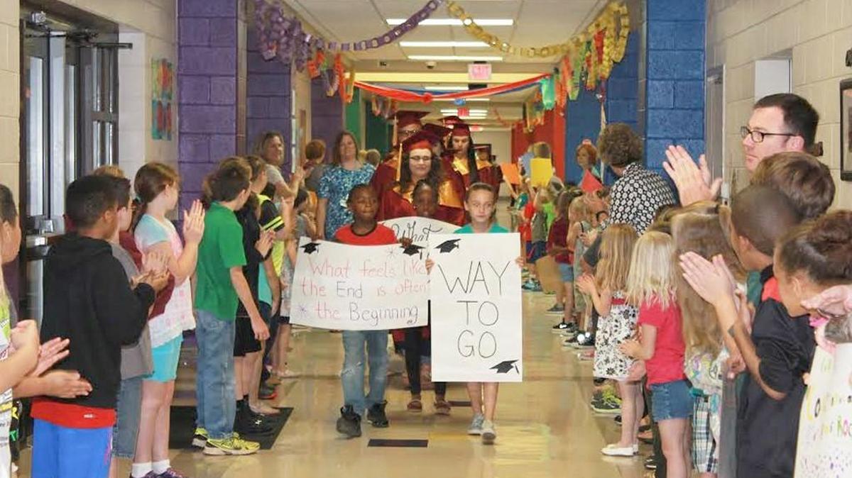 In this 2017 photo, Buford Elementary students Elijah Dixon, Dorianna Johnson and Lexan Melton lead a procession of graduating Lancaster seniors down the elementary school's halls. A new elementary school is coming to the Indian Land area of Lancaster County, which means new attendance zones.
