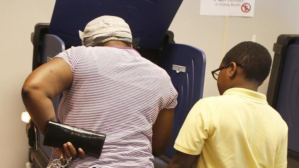 
Shamayne Mason votes at Boyd Hill Center on Tuesday in the Rock Hill school district’s bond referendum. Her son Jimar, 10, a fourth-grader at Finley Road Elementary School, watches.
