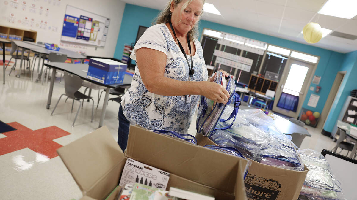 Elizabeth Anderson, kindergarten assistant at Richmond Drive Elementary School, unpacks books Tuesday, July 29, 2025 at the Rock Hill, S.C. school. Kindergarten enrollment decreases across the region are a major reason why school enrollment is down.