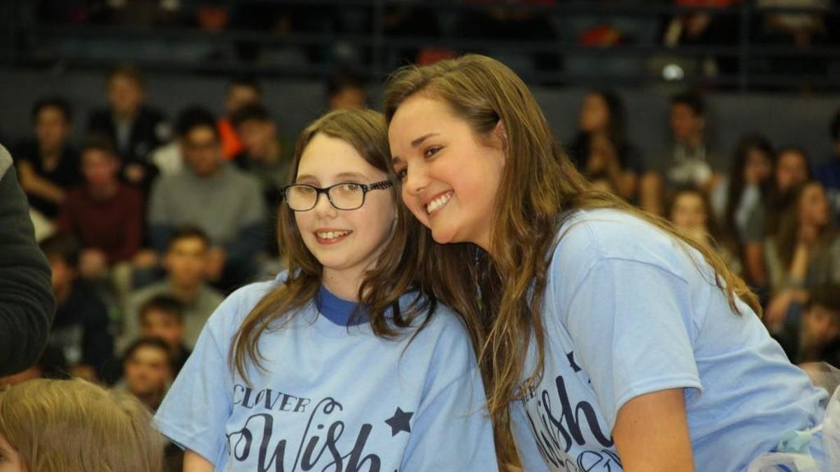 Rihanna, a Make-A-Wish child, is pictured with a Clover High School student during a recent pep rally for Clover Wish Week.