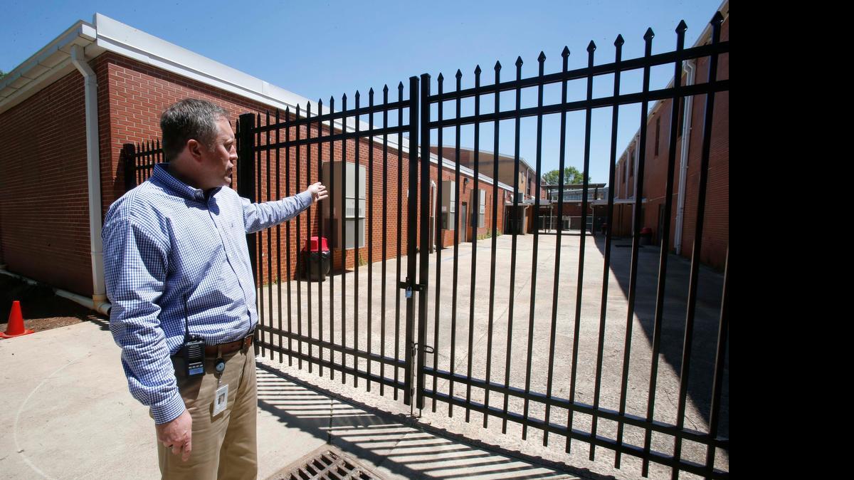 
Sullivan Middle School Principal Shane Goodwin shows a security fence that is opened in the morning as students arrive and locked during the day.
