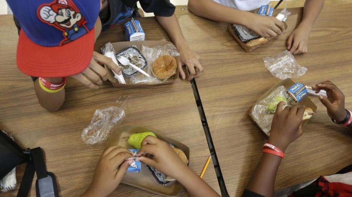 Students enjoy a meal at school.