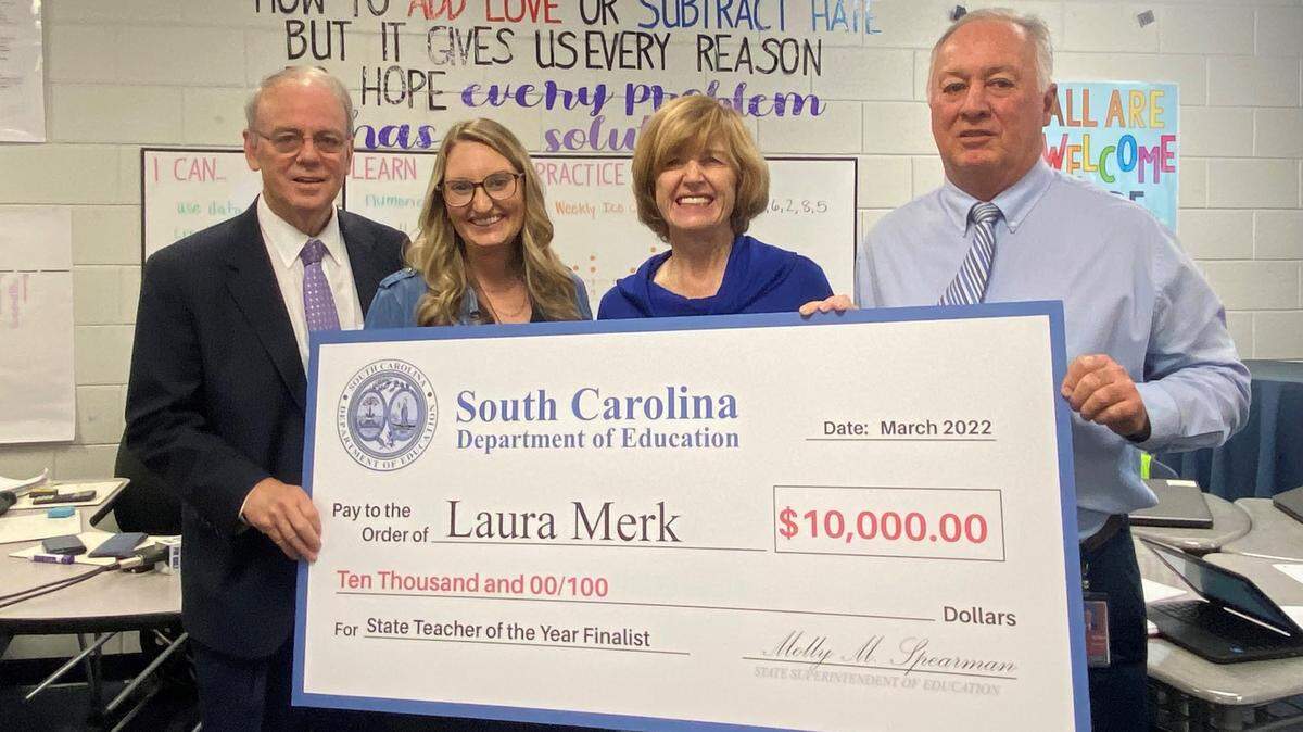 Fort Mill superintendent Chuck Epps, teacher Laura Merk, state education superintendent Molly Spearman and Springfield Middle School principal Keith Griffin celebrate Merk’s finalist status for state teacher of the year.