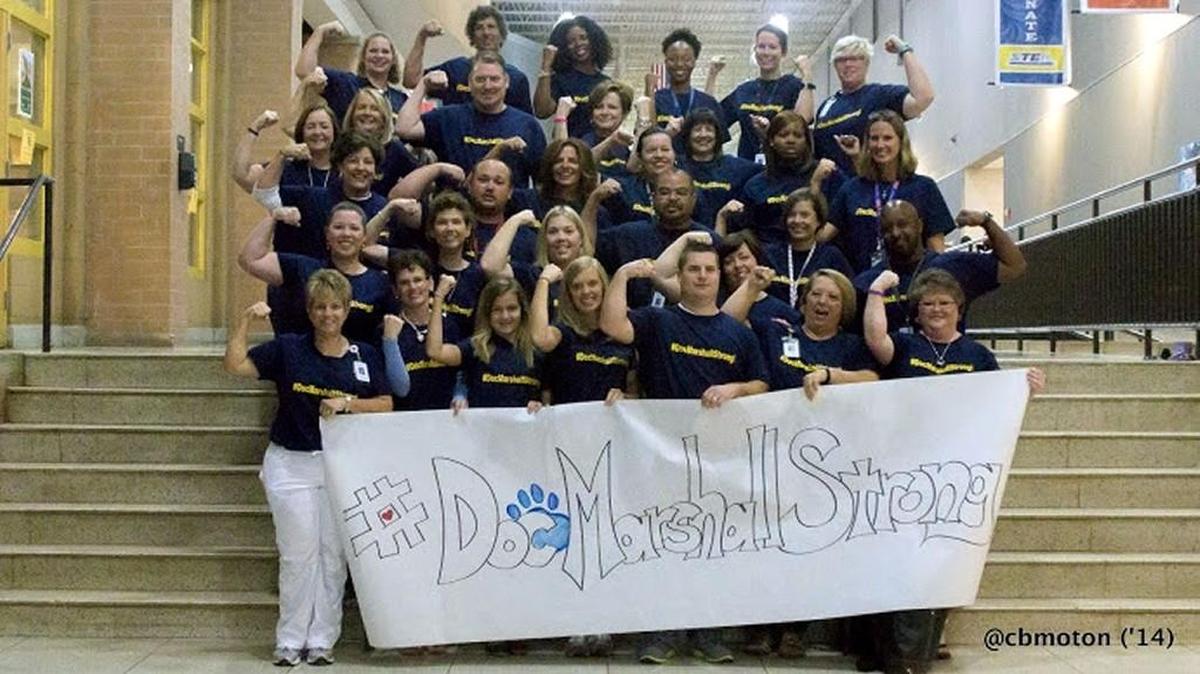 
 As a message of solidarity and strength, students and teachers at Saluda Trail Middle School designed and sold T-shirts to support Julie Marshall. 
