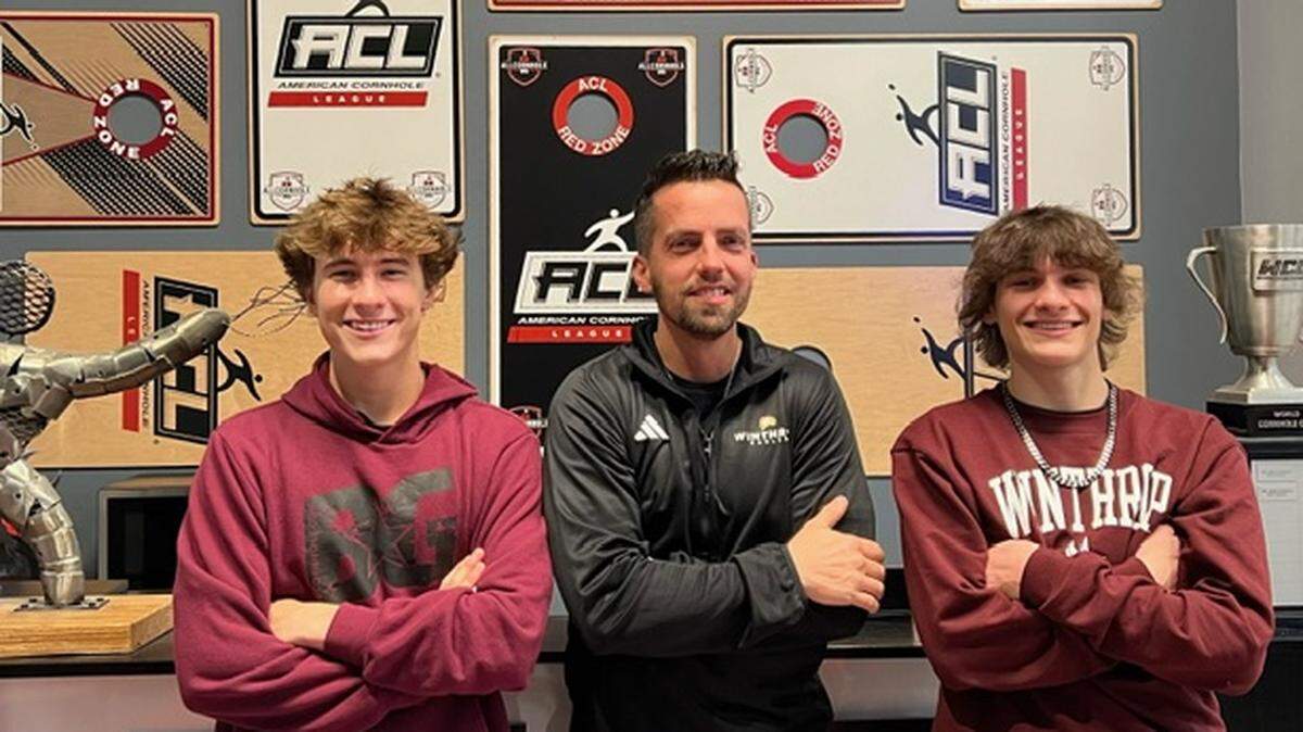 Winthrop cornhole coach Dusty Thompson, center, stands with team signees Gavin Hamann and Jaxson Remmick. They are the first two players to sign with Winthrop’s new cornhole team.
