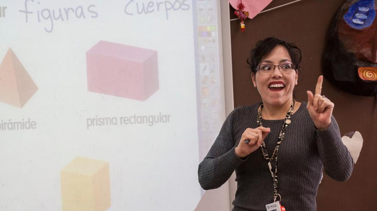 Second grade Spanish immersion teacher Bonnie Jean Avilez DeHudson demonstrates shapes during class Tuesday at Ebinport Elementary School.