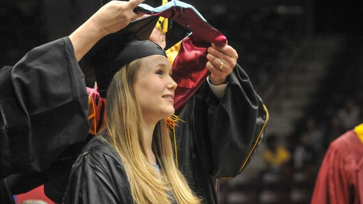 Elizabeth Parkes Burnette recieves her hood for the Master of Education degree during the graduate commencement ceremony at Winthrop University on Thursday.