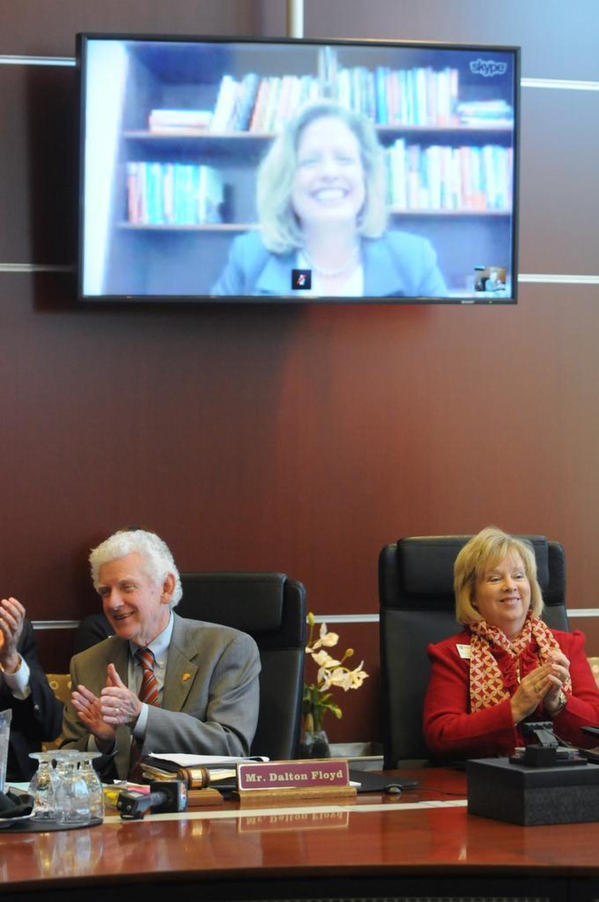 February 2013: Winthrop University Board of Trustees chair Dalton Floyd Jr. and vice chair Kathy Bigham applaud as Jamie Comstock Williamson accepts the job as Winthrop's next president via Skype.
