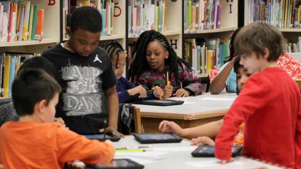 Third graders at Northside Elementary School work in the library on Tuesday. The Rock Hill school board has approved more money for instructional supplies like books.