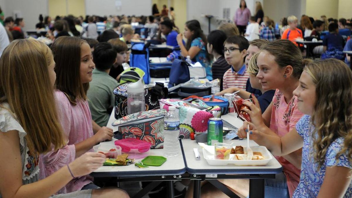 Pleasant Knoll Middle School students chat during lunch in Fort Mill on the first day of classes in August. Fort Mill’s Ol’ School Crowd, a group of Fort Mill High School graduates, is raising money to help offset costs of lunch for students in need.
