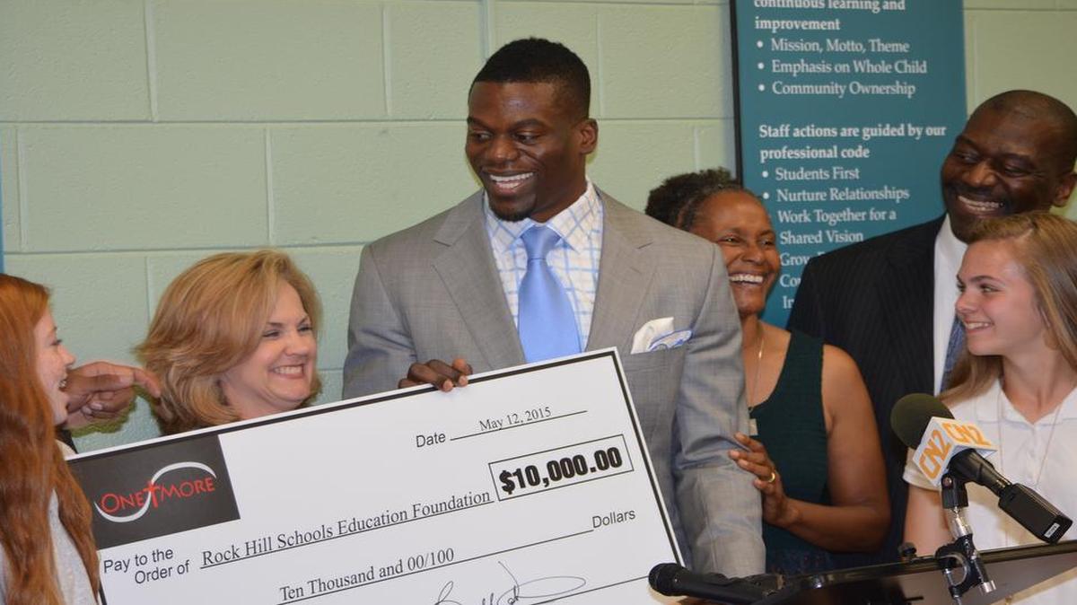 
Ben Watson presents a $10,000 ceremonial check to Rock Hill Superintendent of Schools Kelly Pew during Tuesday ceremony. The money will go the Rock Hill School Education Foundation to fund future grants. 
