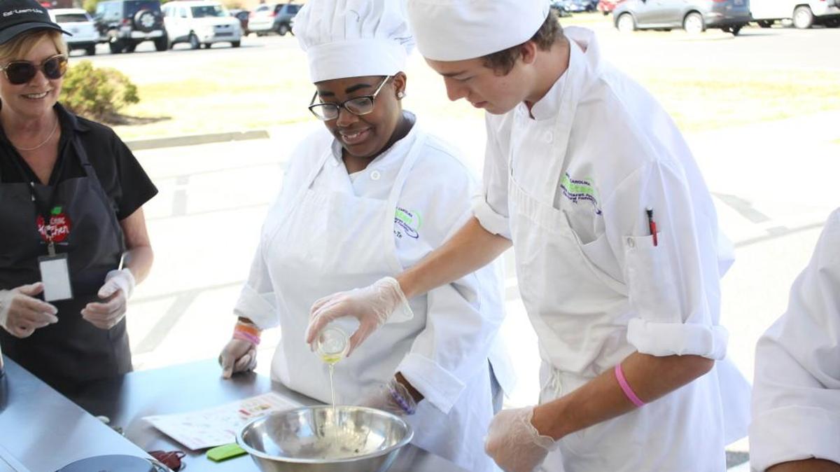 Clover students Talaijah Blackmon and Stephen Nivens learn how to cook a healthy meal on Oct. 6 during a visit from a Chartwells K12 mobile kitchen.