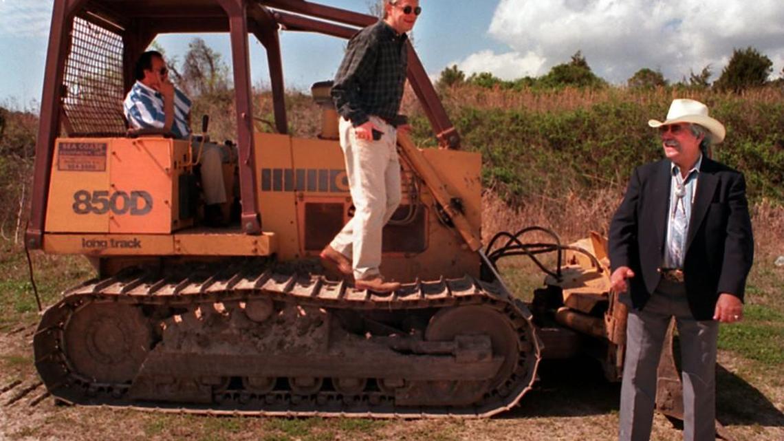 Standing at the future site of the Catawba Indian Nation’s bingo parlor in March 1997, Chief Gilbert Blue, right, laughs along with consultant Bobby Price while talking about the previous night’s vote by the North Myrtle Beach City Council. Seated in bulldozer is Catawba Tribal member Carson Blue.