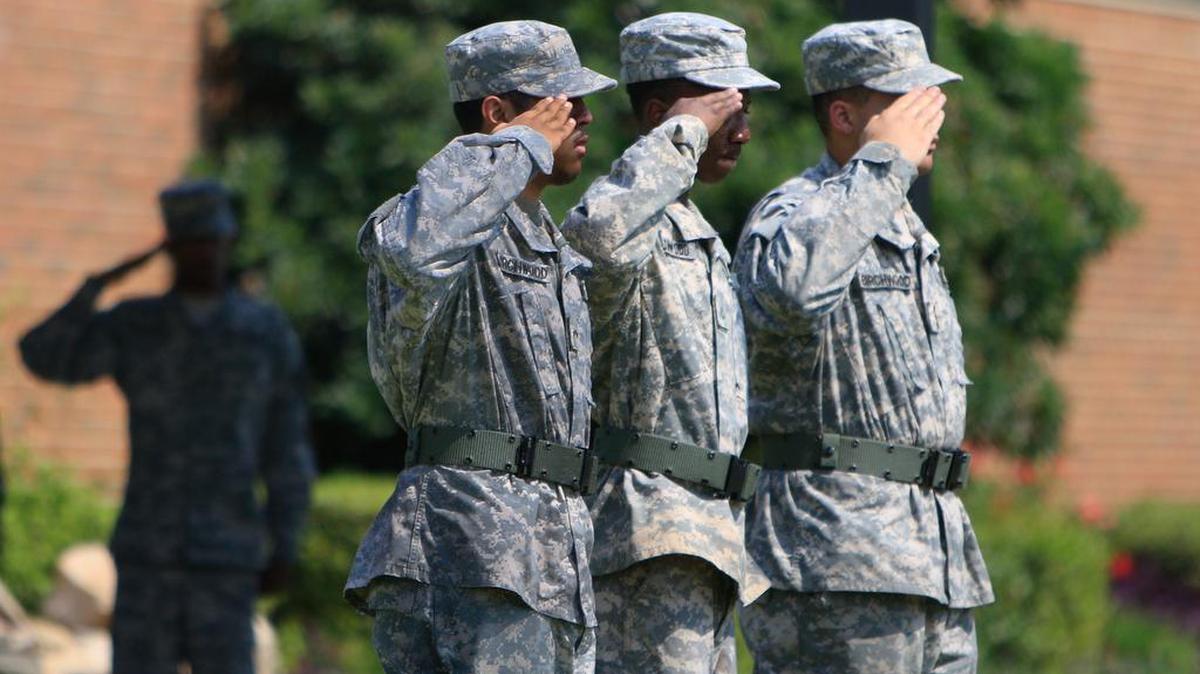 Members of the Birchwood High School Junior ROTC detachment at DJJ salute after lowering the American Flag to half staff during a program in remembrance 9/11.