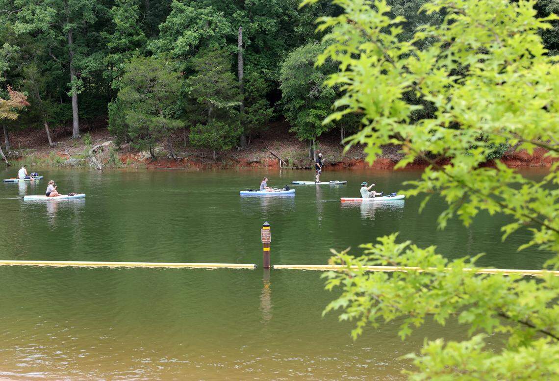 Paddlers venture past the swimming area at Rock Hill Lake Park on a recent Saturday.