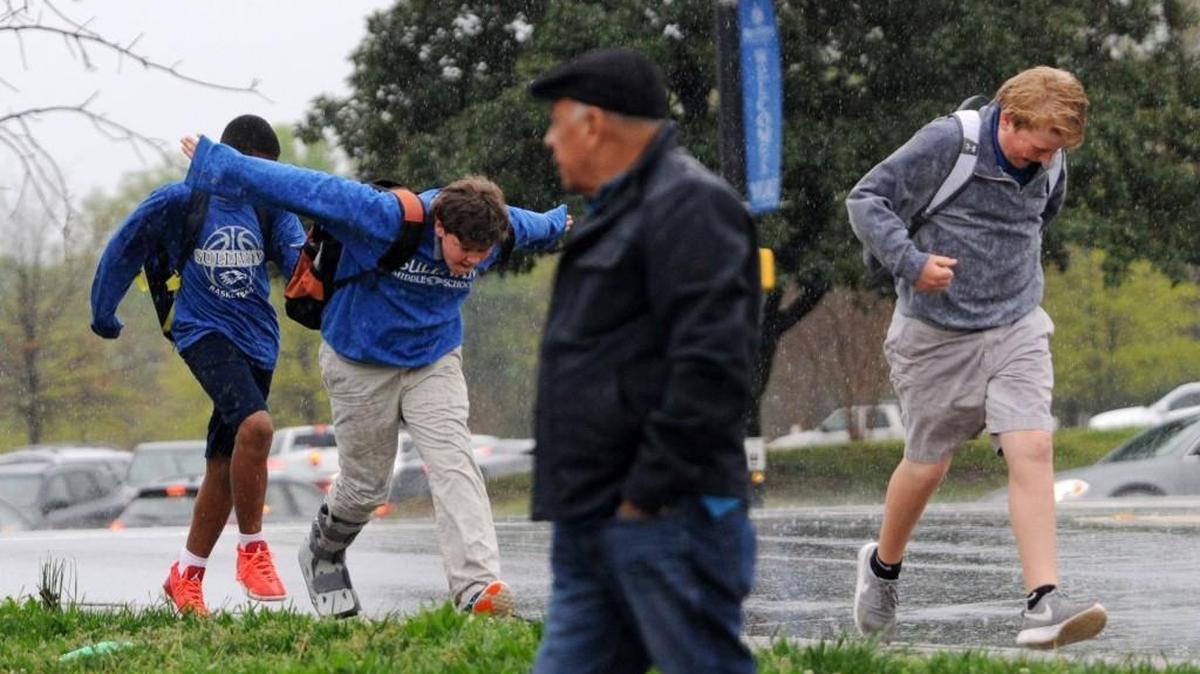Sullivan Middle School students and a pedestrian walk in the rain earlier this month on Ebinport Road in Rock Hill.