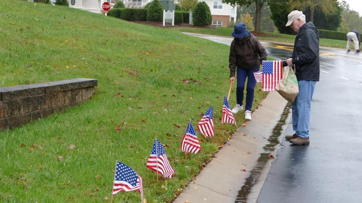 John and Rosemary Lyon braved the rain earlier this week to line the drive of Park Pointe Village with American flags ahead of Veterans Day. Bad weather didn’t stop volunteers decorating the retirement community off Highway 5 in Rock Hill for the holiday. John Lyon is himself a retired Air Force captain.