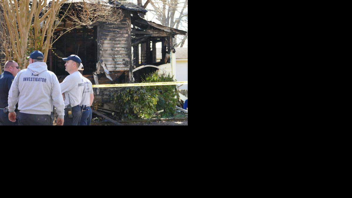 
Investigators at the scene of a house fire on Smith Street in Clover on Sunday. Authorities determined two separate blazes at neighboring houses were not connected and both started on their own, triggering a dual investigation into the cause by the fire marshal. No one was home at either house when the fires broke out early Sunday morning.
