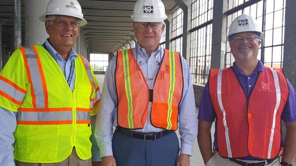 Gary Williams of Lowenstein Partners stands with Eddie Williams and John Gast of Keck & Wood during a tour of the Lowenstein Building in April 2017.