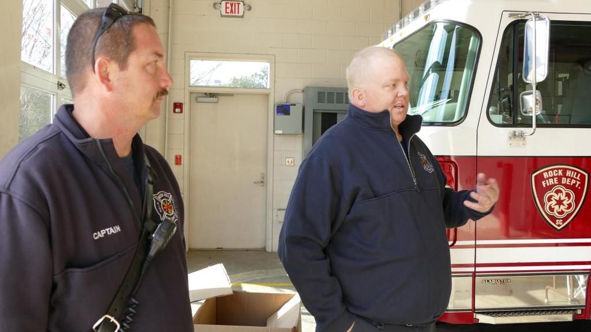 Firefighter Chuck Mozingo, right, talks about his battle with cancer at Fire Station 2. Mozingo’s fellow firefighters are holding a fundraiser for the Mozingo family on Friday. At left is Mozingo’s fire captain Mike Jadwinski.
