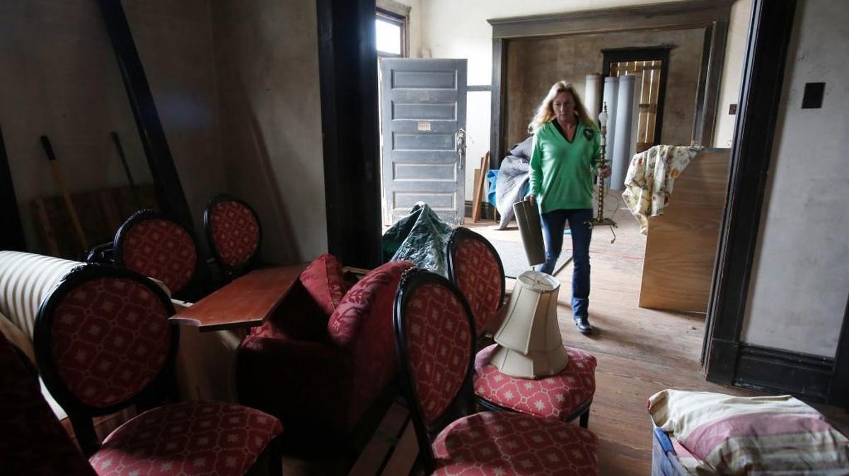 The Fennell House is getting decorated for Christmas. The owners of the historic house on Confederate Avenue are hoping the holidays will help them raise money to finish work on the exterior, including putting the sweeping porch back on the home. Kimberly Neill of Kimberly Neill Designs moves furniture into the house for Christmas.
