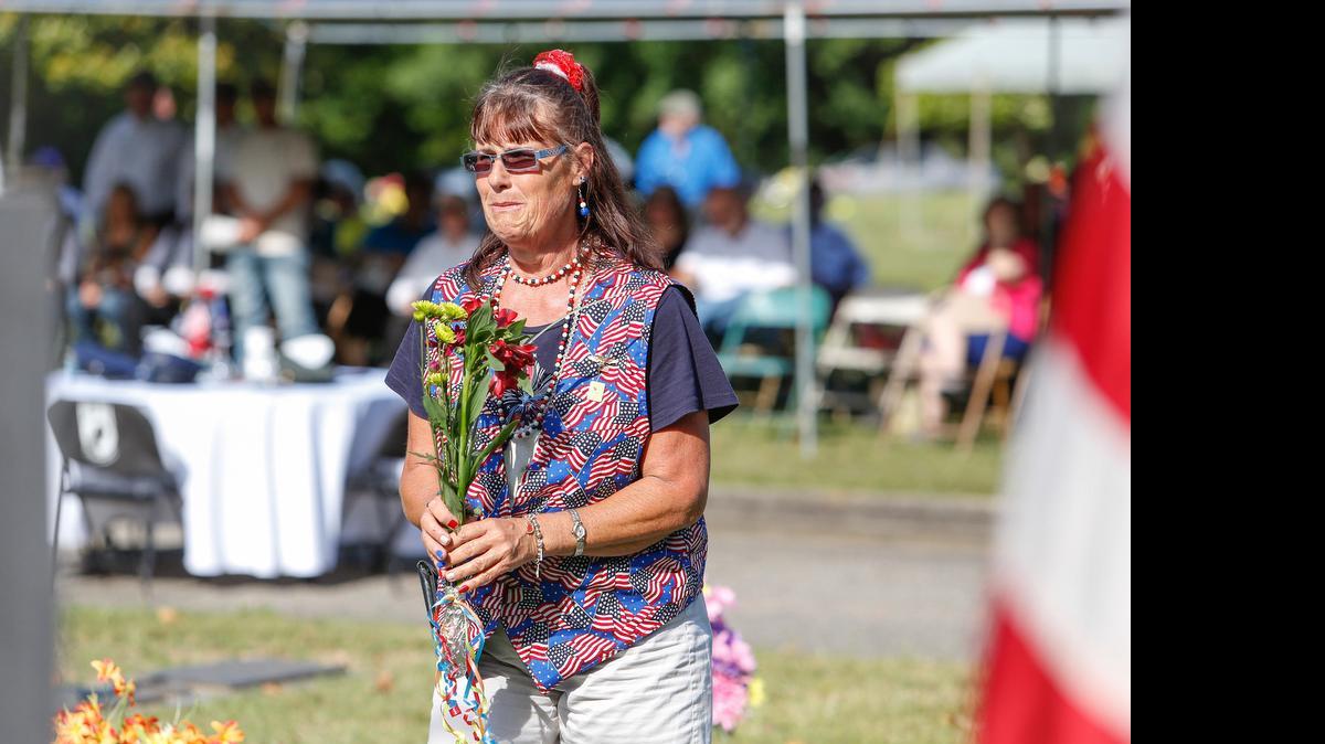 
Melinda Brown chokes back tears as she places flowers for the fallen soldiers of the Korean War during a recent Memorial Day ceremony at the York County Veterans Memorial
