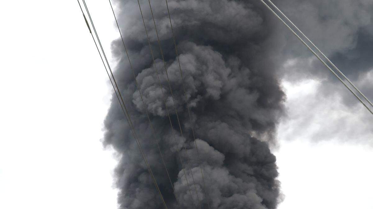 A fire in a scrapyard and storage area of Carolina Poly in Chester County Monday sends large plumes of smoke into the air.