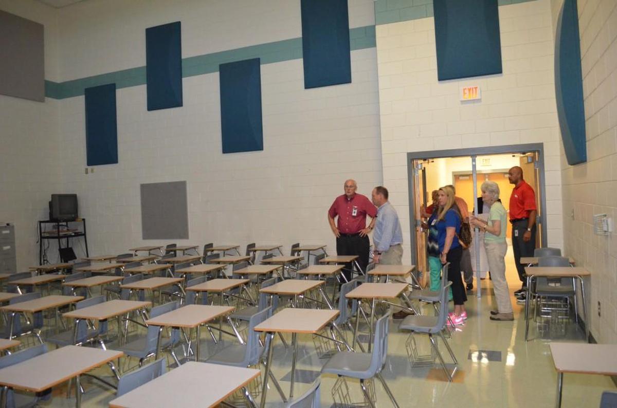 Members of the Rock Hill School Board examine a classroom Friday that school and district officials want to convert in a practice area for the Stallions’ wrestling team. 
