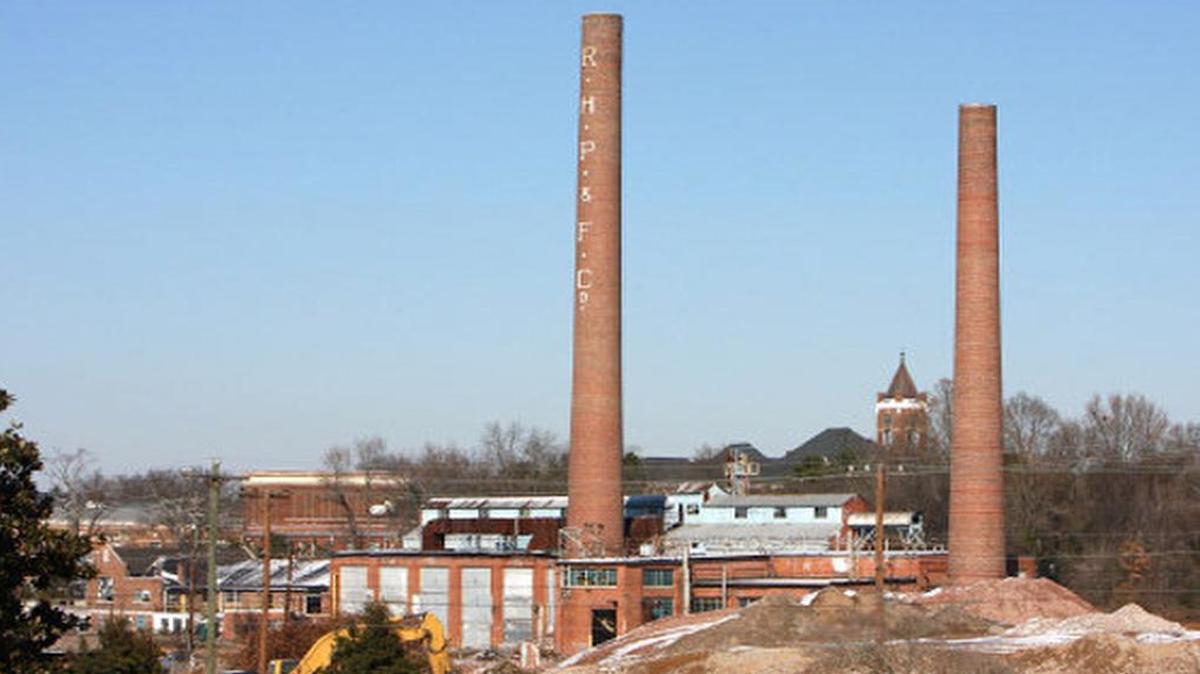 A 2011 file photo shows the power plant building and remains of the Rock Hill Printing & Finishing Co. Winthrop University’s Tillman Hall can be seen in the background.