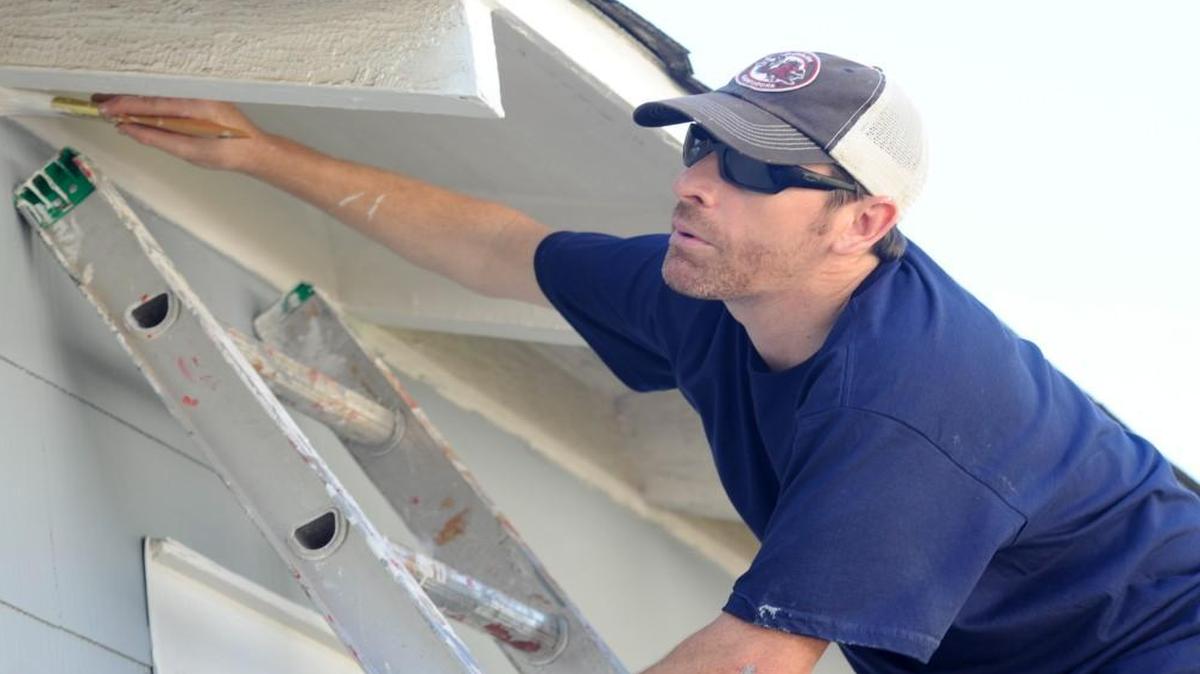 
Brad Blackmon helps paint the home of Don Manus Saturday as part of the annual Rolling in Rock Hill event.
