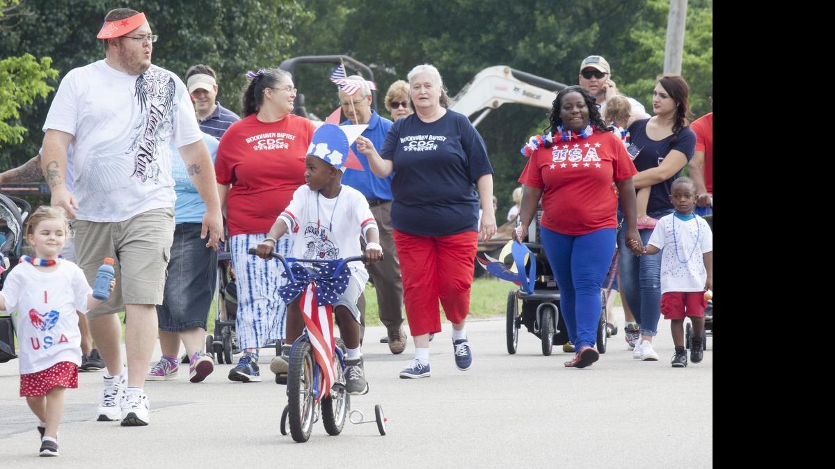 
Festive children and adults gather Thursday at Woodhaven Baptist Church for the annual 4th of July parade.
