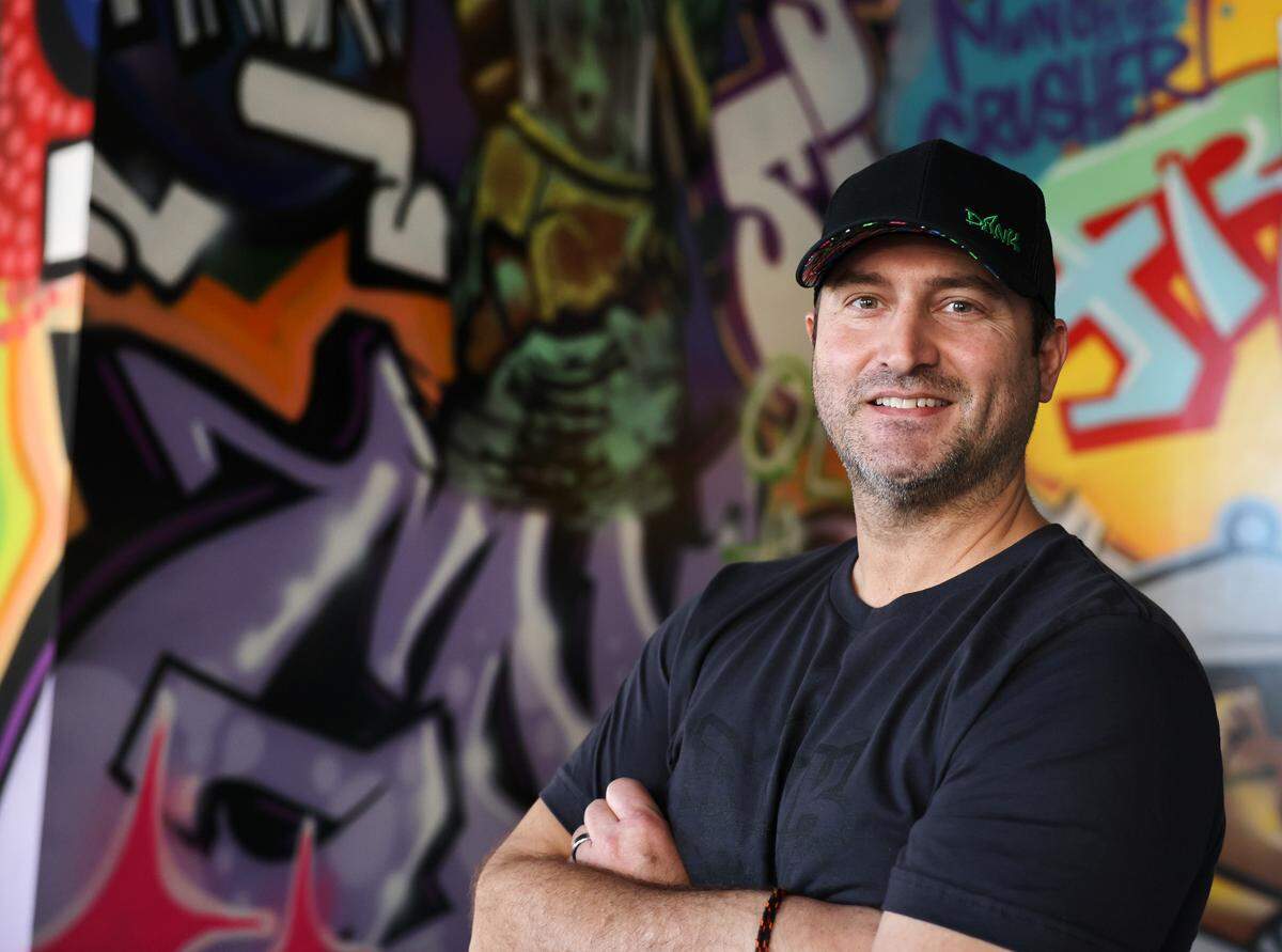 Justin Miller, owner of the Rock Hill Dank Burrito, stands near one of the restaurant’s murals Monday at the store in Knowledge Park.