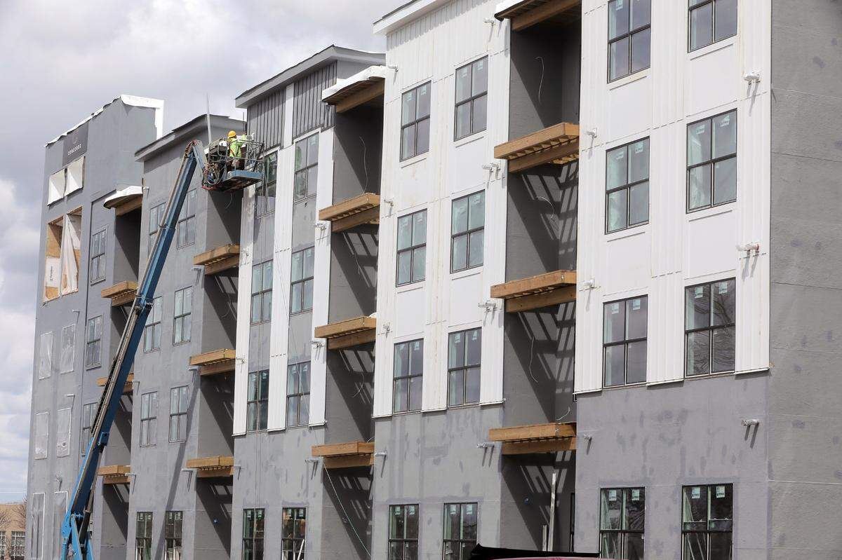 In this file photo, a construction team member works on a section of The Exchange apartment complex in downtown Rock Hill. A state law that allows apartment complexes to become nonprofits is impacting city finances and likely will lead to increased taxes, city officials say.