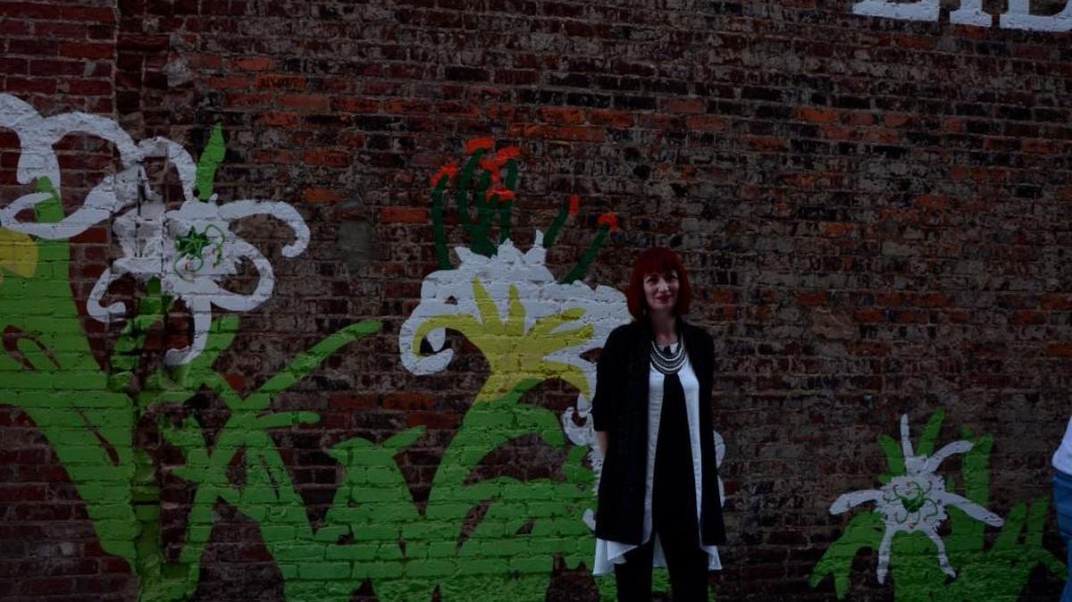 Sharon Dowell and the Freedom Walk mural she designed in downtown Rock Hill.