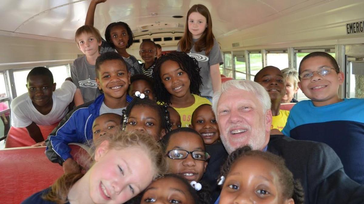 David Carriker, surrounded by children from the Boys & Girls Clubs of York County. Carriker, who has been the clubs executive director for four years, is leaving for a similar post in Wilmington, N.C.