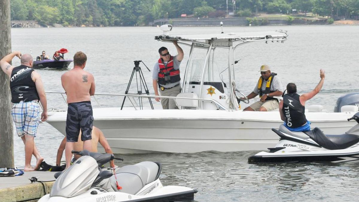 Public information officer Trent Faris and Sgt. Ed Ware of the York County Sheriff's Office lake patrol meet with boaters at Buster Boyd Access Area on Lake Wylie.