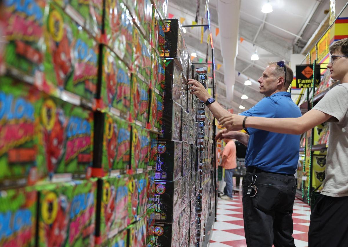 Terry Aaseby, left, and Trevor Aaseby shop for fireworks Wednesday at Red Rocket in Fort Mill.