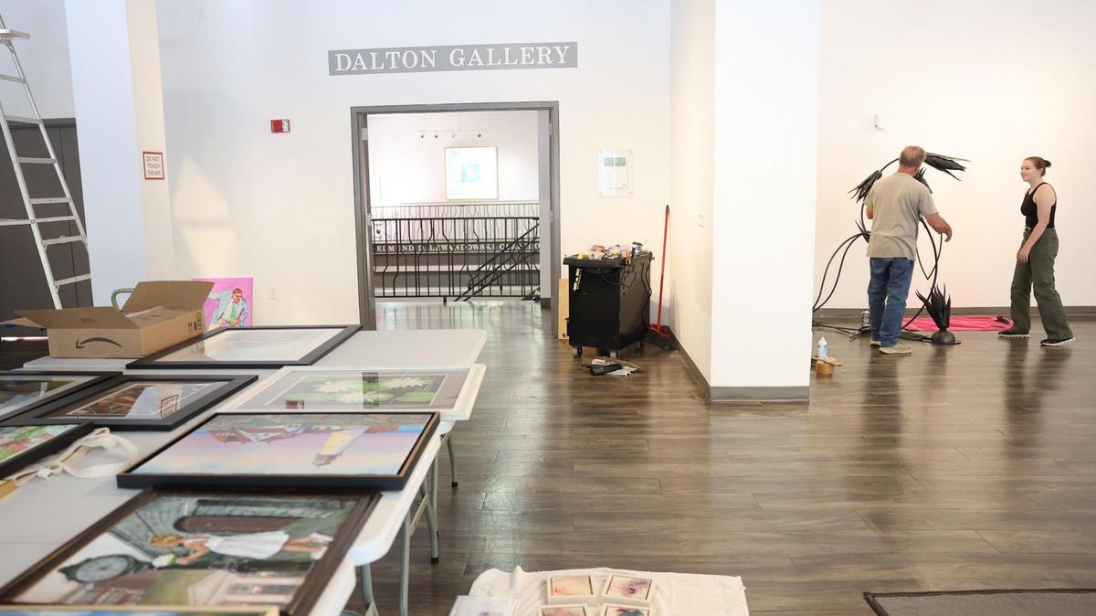 Artist Randy Weiss, left, and Annie Heisel, Center for the Arts gallery manager, install a sculpture Tuesday at the center in Rock Hill. Federal funding cuts for the arts haven’t significantly impacted Rock Hill.