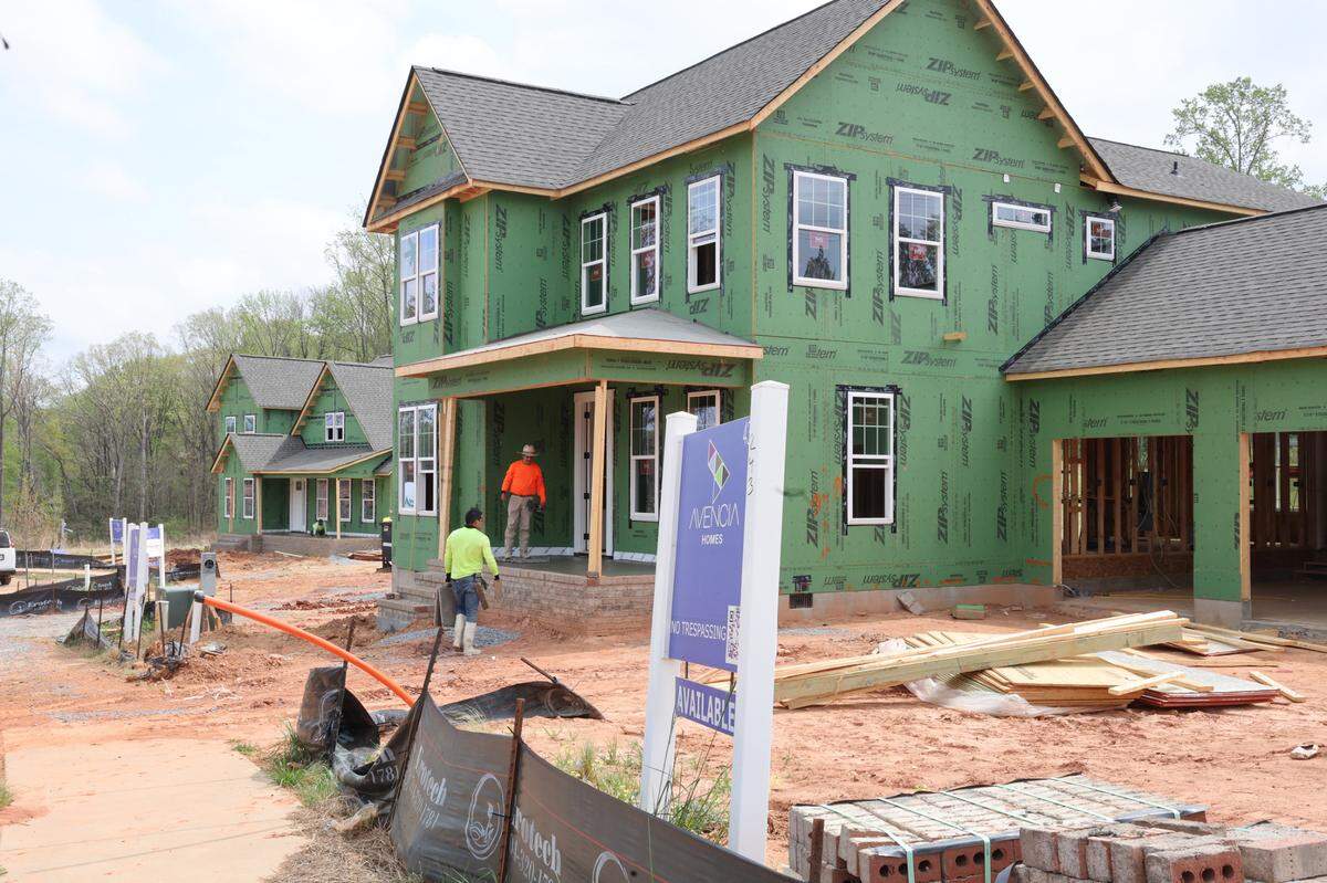 A construction crew works on a new home in the Riverwalk community in Rock Hill earlier this year. High-end home sales are on the rise across York and Lancaster counties, as their population increases.