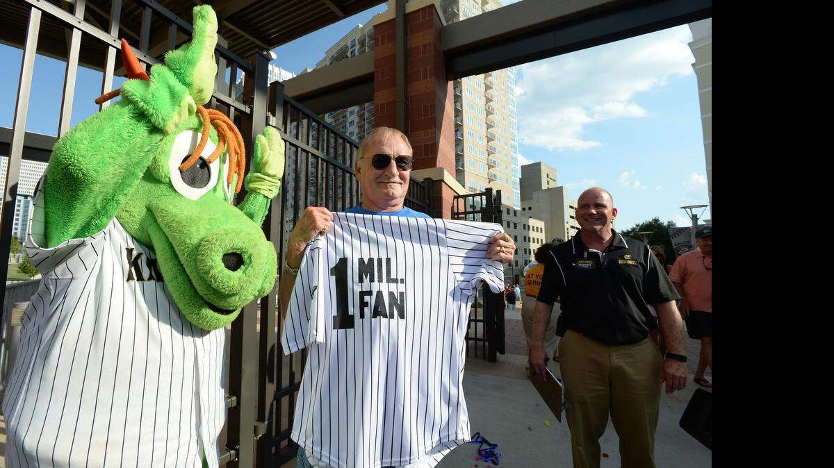 
The Charlotte Knights' 1 millionth fan at BB&T Ballpark, Rock Hill’s Bill Lavell, center,  poses with Charlotte Knights Mascot "Homer" Scotty Brown on Wednesday, June 17, 2015. Lavelle took home free peanuts, a ticket upgrade, a personalized jersey, an autographed baseball, two tickets to the WBT Skyshow  and the Triple A All-Star Game and a $1,000 gift card to Diamonds Direct.
