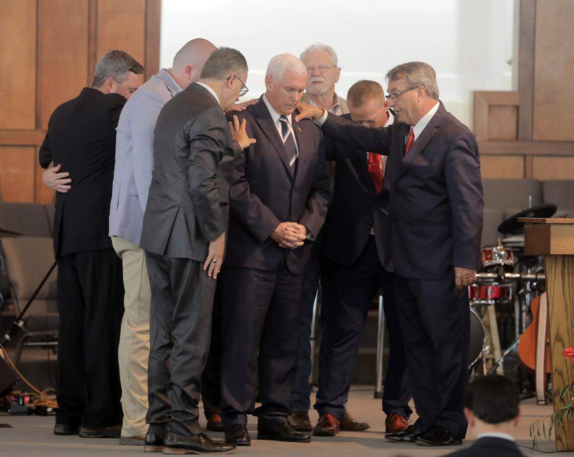 Members of the clergy pray for former Vice President Mike Pence Thursday at Lakewood Baptist Church in Rock Hill.